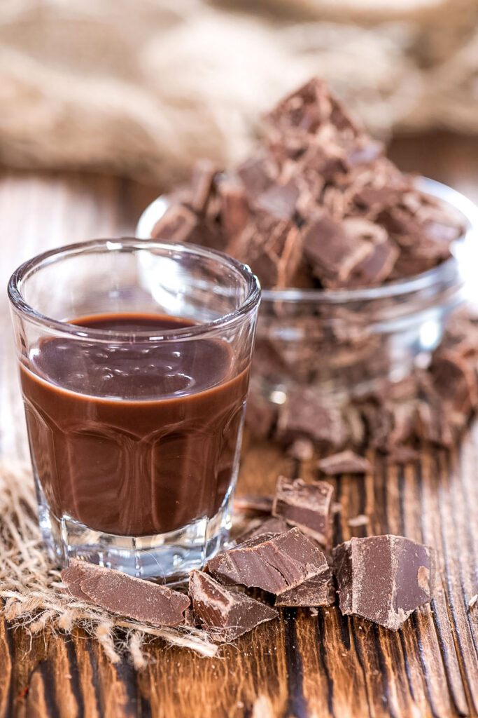 This easy chocolate liqueur recipe is an old family treasure that is made with cocoa powder. Perfect gift for the holidays and inexpensive. Chocolate liqueur in a glass0