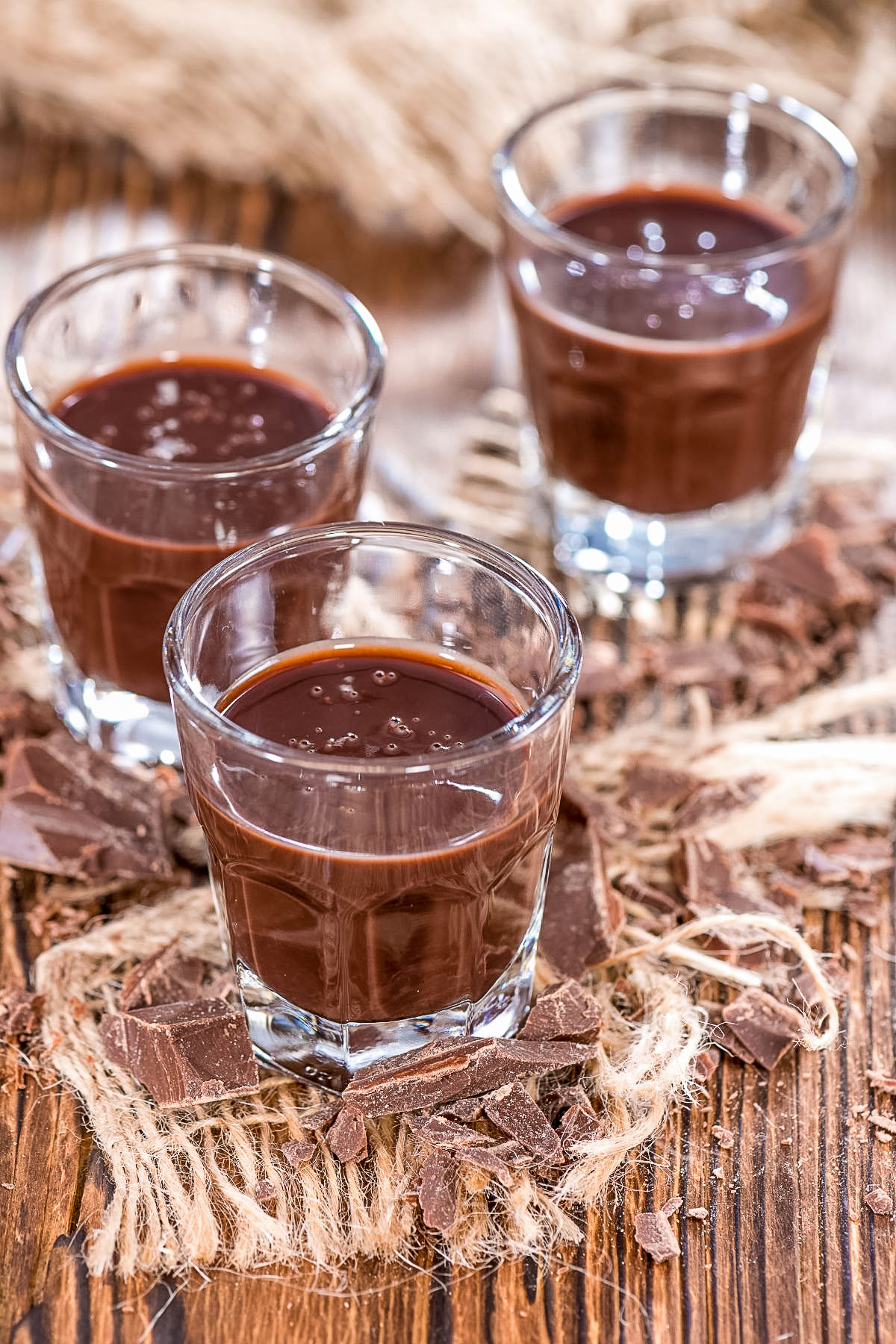 This easy chocolate liqueur recipe is an old family treasure that is made with cocoa powder. Perfect gift for the holidays and inexpensive. Chocolate liqueur in three glasses on table0
