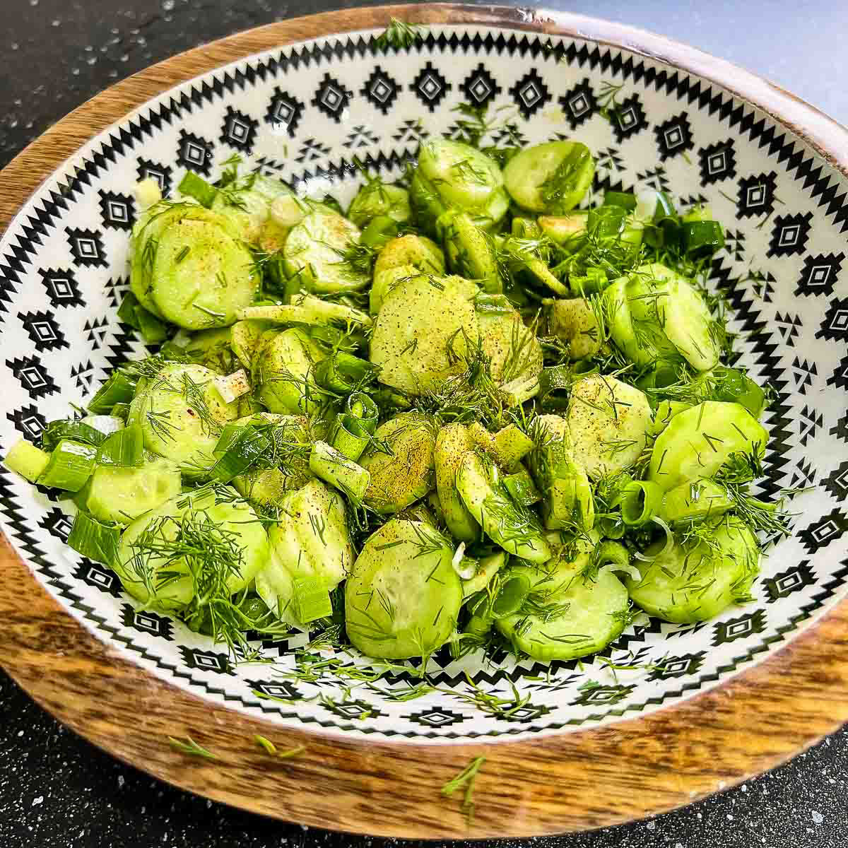 Cucumber salad in a wooden bowl square image0