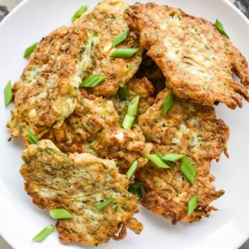 Zucchini Feta Fritters on a white plate.