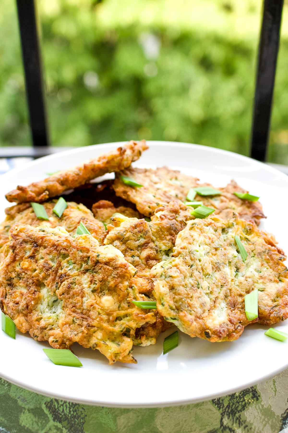 Zucchini Fritters With Feta on a white plate.