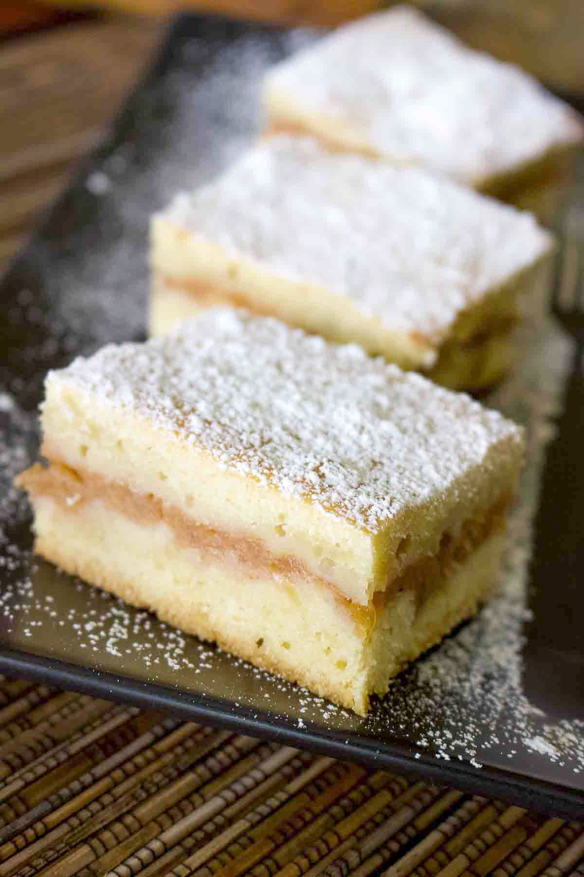 Slices of Apple Pie on a black plate.