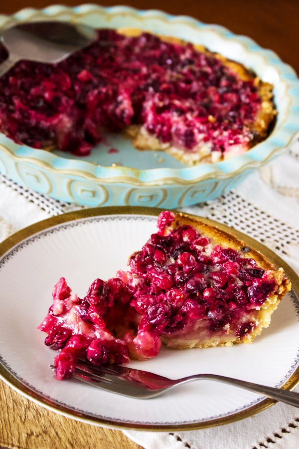 Cranberry Custard Pie With Cream Cheese Crust - slice of pie on a white plate with golden rim
