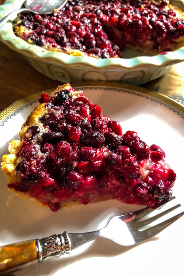 Cranberry Custard Pie With Cream Cheese Crust on a white plate with a fork