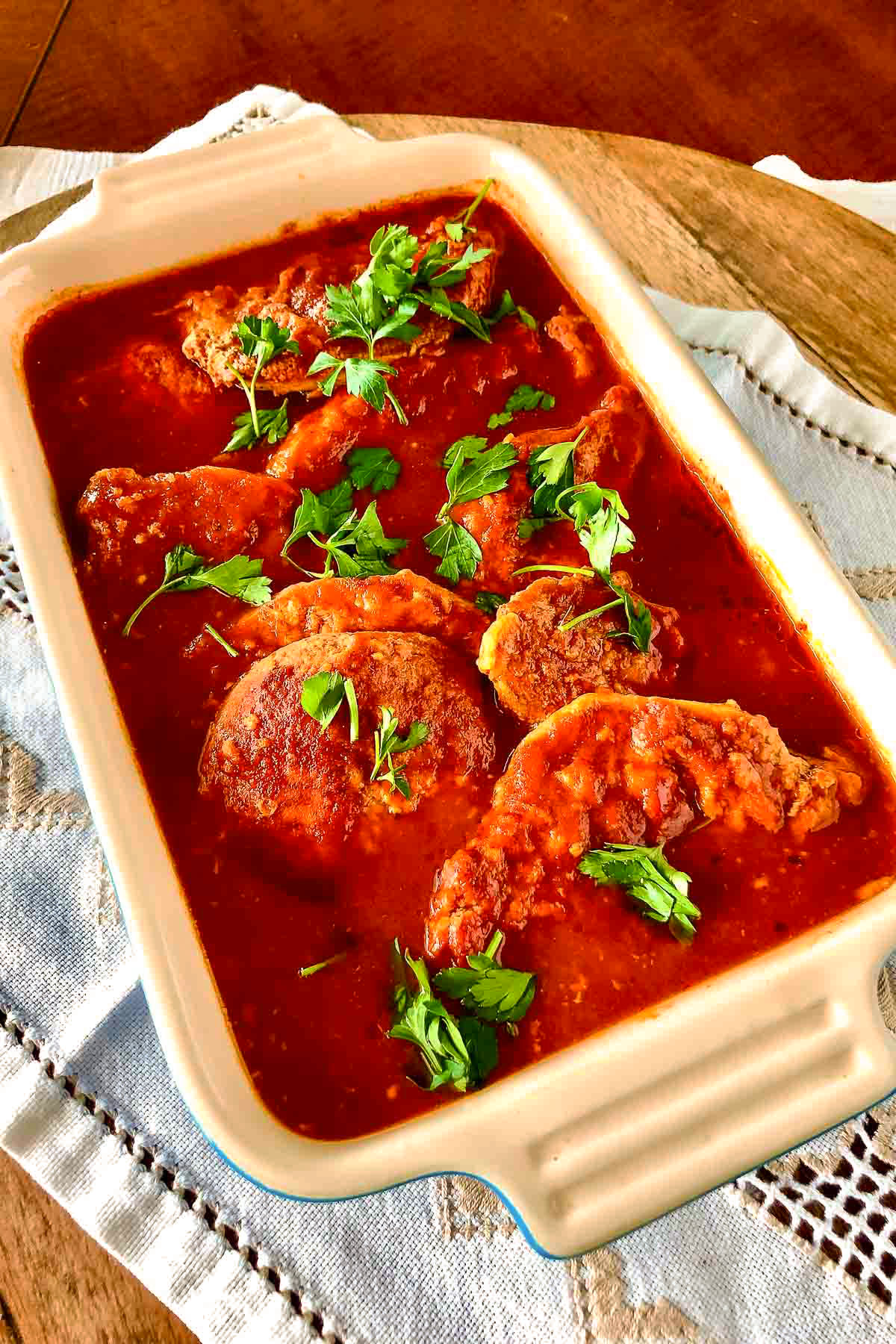 Pork in garlic tomato sauce in a baking pan.