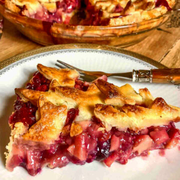 Slice of Apple and Berries Pie on a white plate.