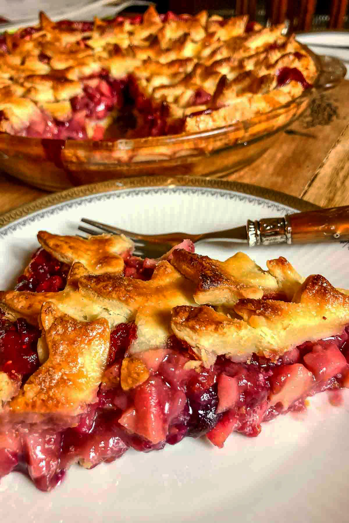 Slice of Apple and Berries Pie on a white plate.