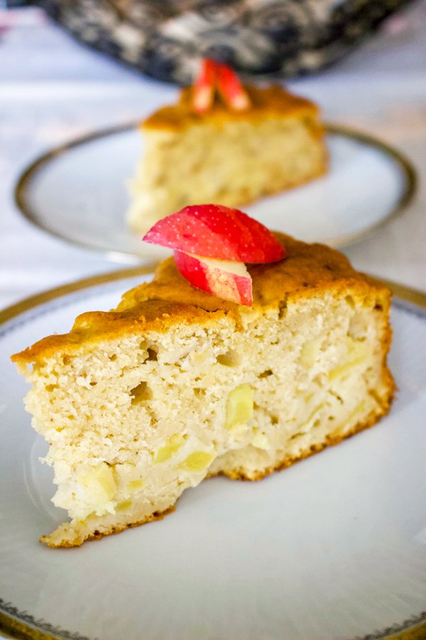 Say hello to this German Riesling Apple Cake. This is an easy, delicious cake that is made with Riesling wine and tart apples. It can also be made for any occasion, including holidays. German Apple Cake slices served on dessert plates.