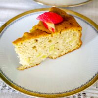 German Apple Cake slice on a white and golden plate.
