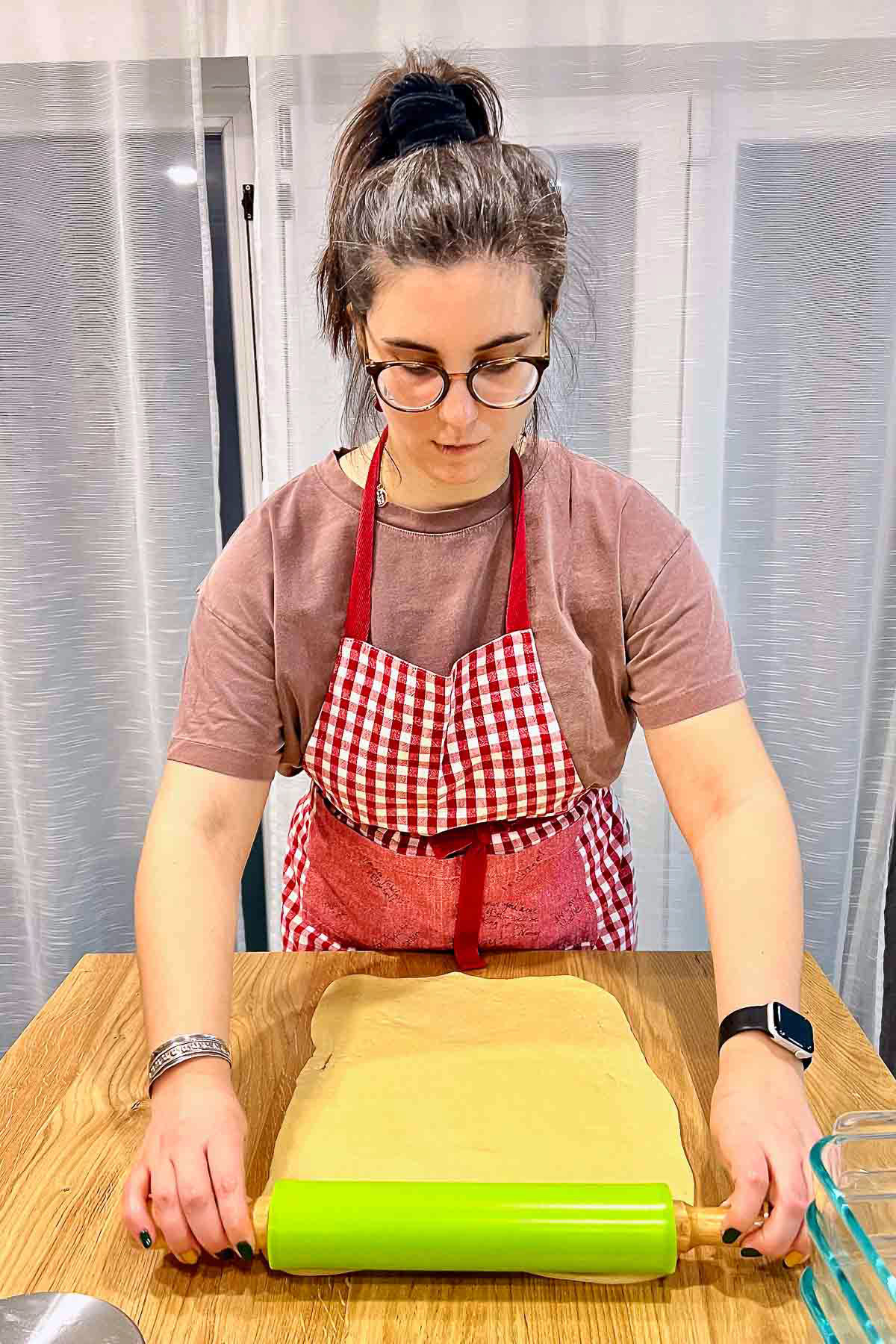 Baker preparing the dough for filling and rolling.
