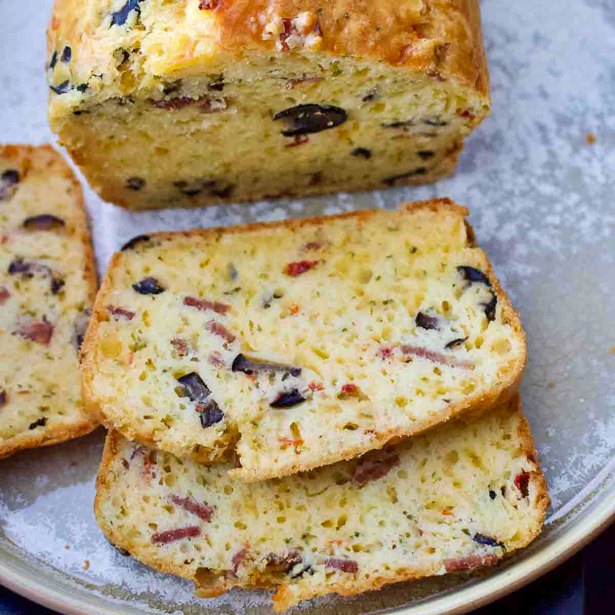 Cheese and Olives Quick Bread sliced on a platter.