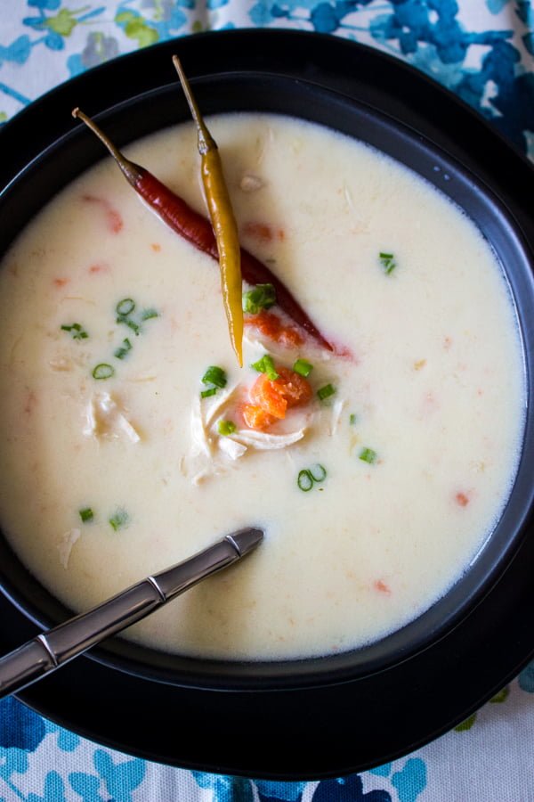Chicken Soup With Sour Cream And Garlic is a Romanian soup also called "Ciorba Radauteana". Delicious and very nutritious. Chicken Soup With Sour Cream And Garlic-overhead picture of the soup in a black bowl served with hot peppers