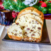 Quick Sweet Bread with Yogurt Nuts and Dried Fruit on black plate.