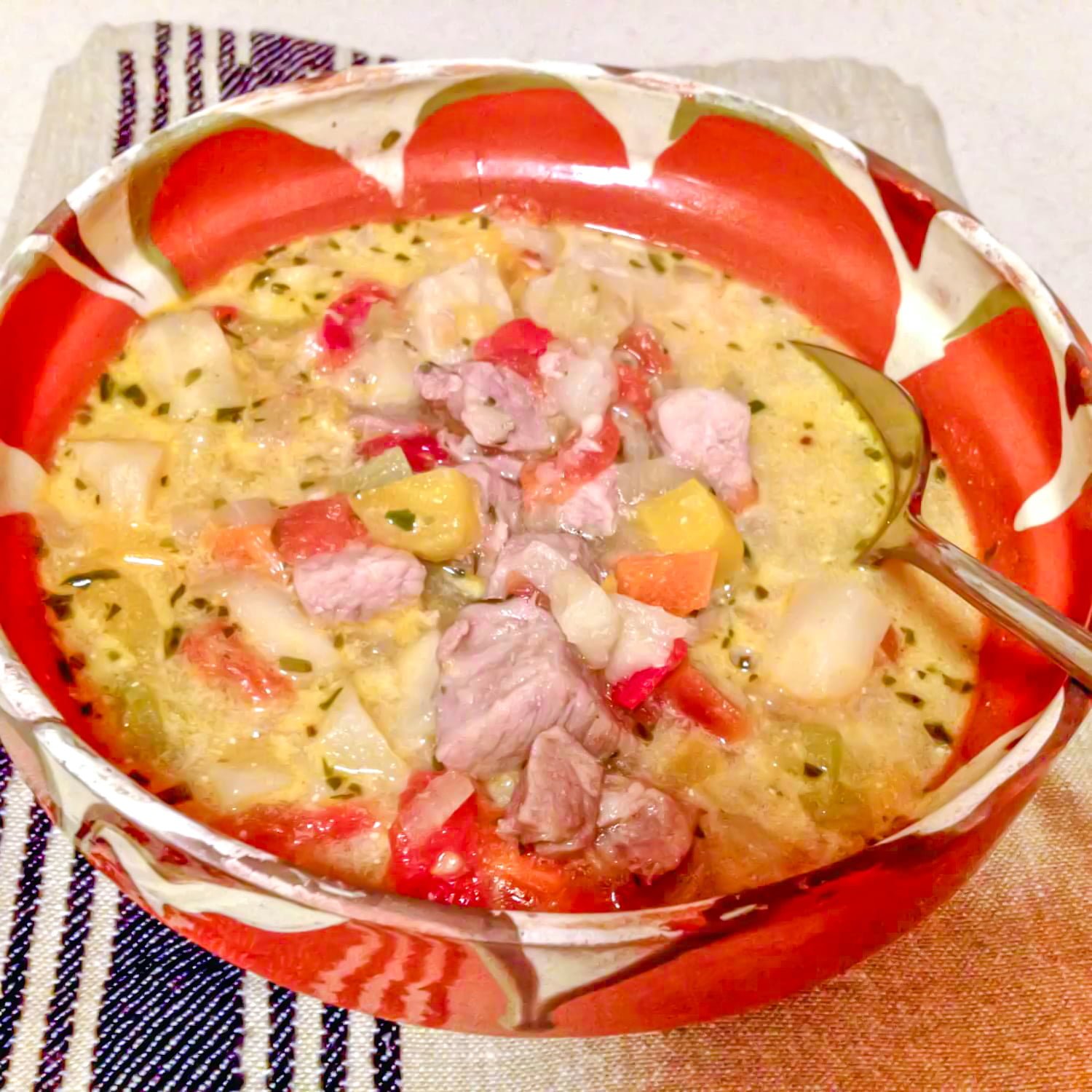 This traditional Romanian sour soup with pork and vegetable is a recipe that is made in many regions of Romania. Traditional Romanian Sour Soup with Pork and Vegetables in a bowl- featured picture
