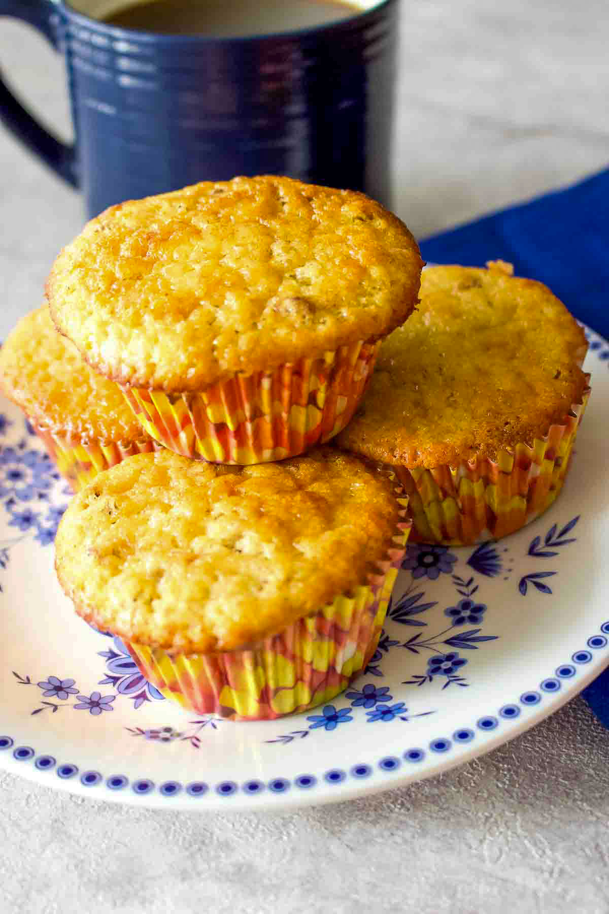 Here you have a no fail easy banana nut muffins recipe that is delicious and perfect for breakfast or as a snack. Banana Nut Muffins on a white and blue plate.