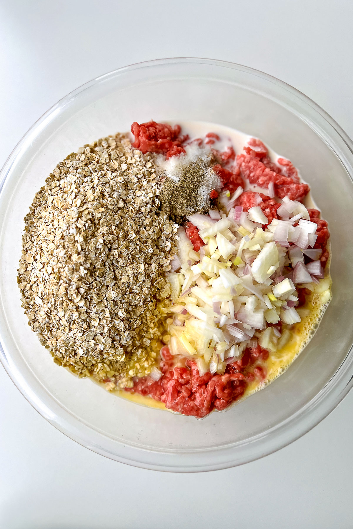 Bowl with ingredients for meatloaf with oats0
