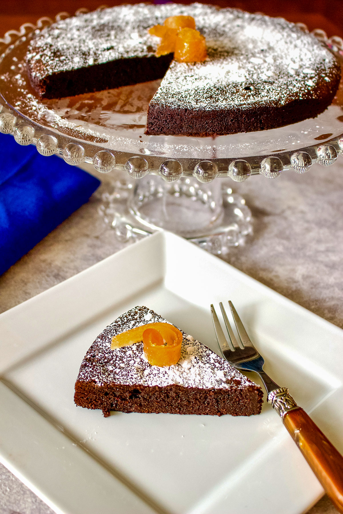 Easy Flourless Chocolate Cake on stand with slice on plate0