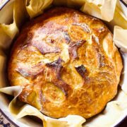 No Knead Bread baked in a cast iron pot with parchment paper.