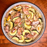 Sheet Pan Chicken with Acorn Squash, Apples And Fennel baked in a round baking tray.