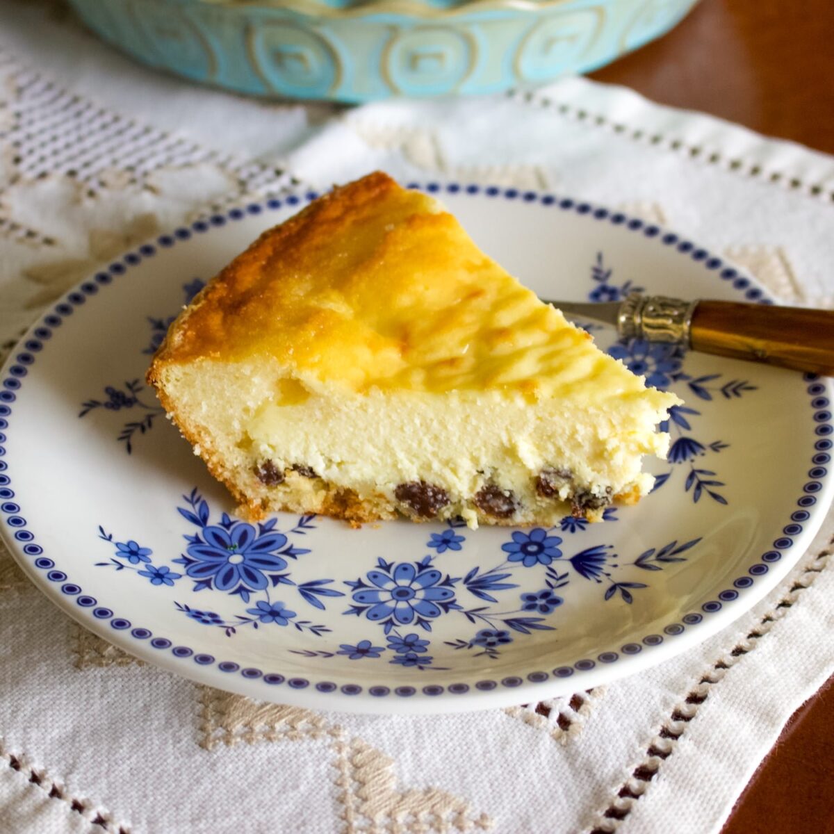 Delicious Easter Cheesecake slice on white and blue plate with fork.