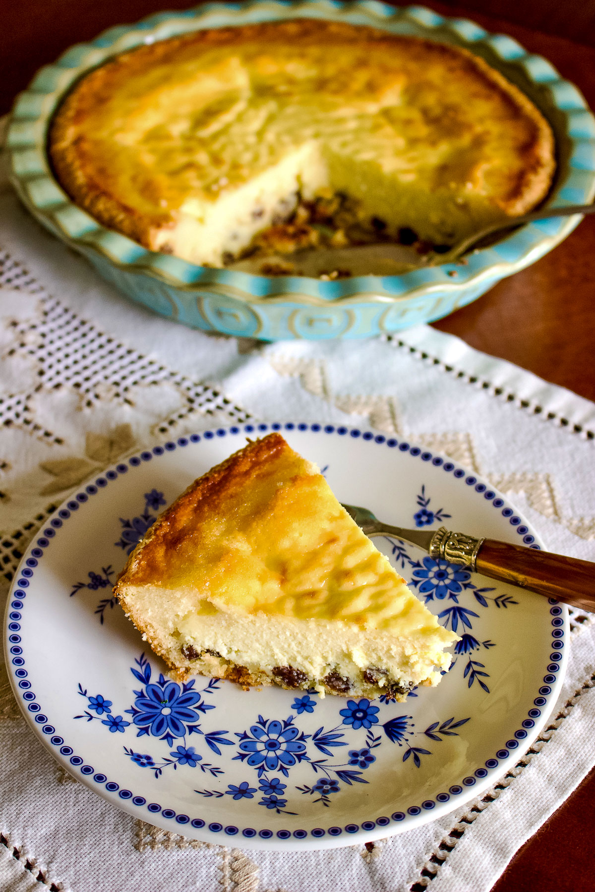 Romanian Easter Cheesecake slice on white and blue plate