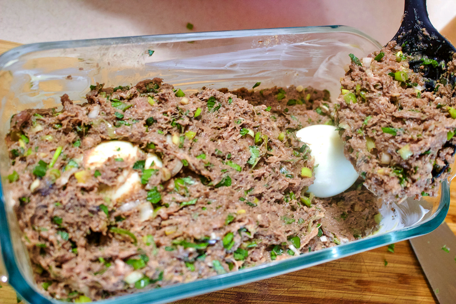 Romanian Easter Meatloaf- filling the baking pan with more ground meat mixture