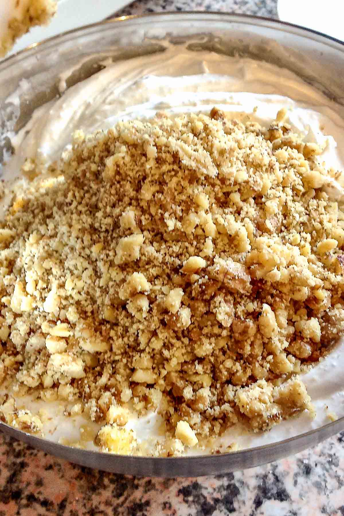 White eggs and walnuts in a bowl.