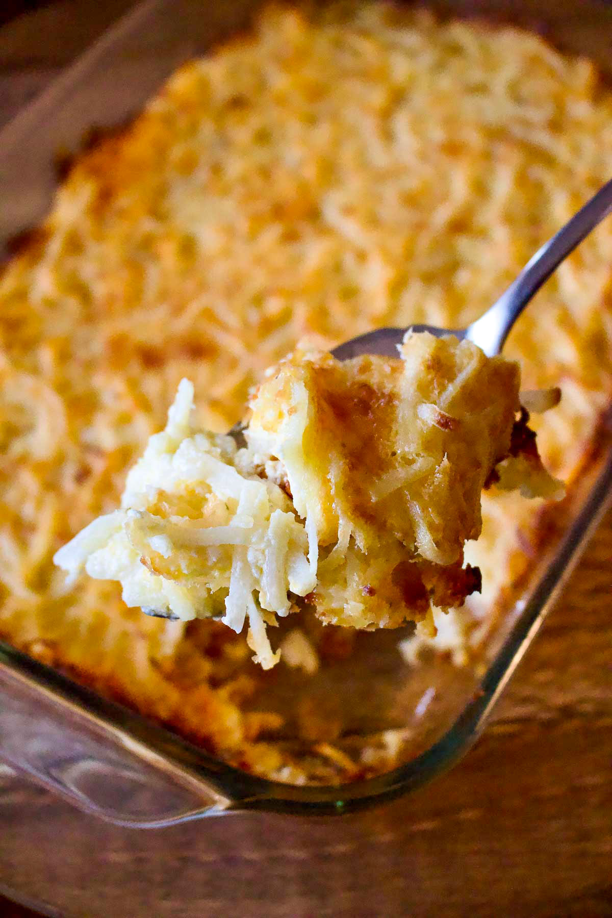 Delicious Hash Brown Casserole in a baking dish with spoon.