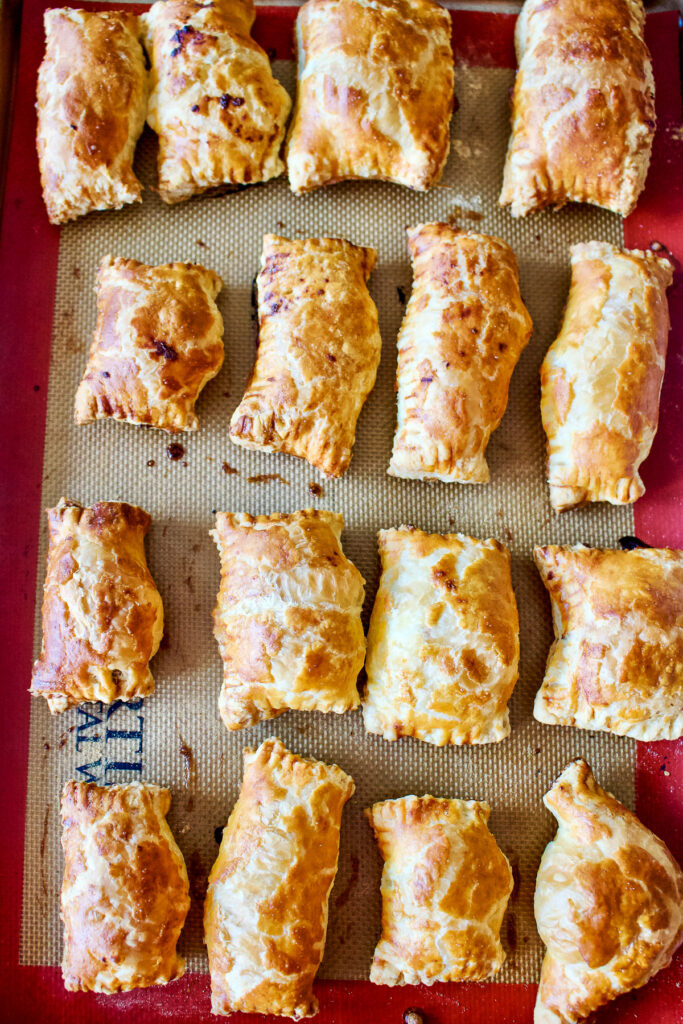 Sweet cheese pastries on baking tray0