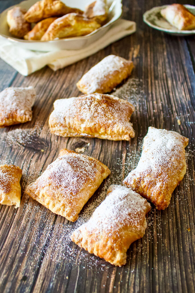 Sweet cheese pastries on table with platter in the background0