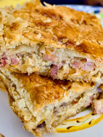 Baked onion and ham puff pastry pie slices square image0
