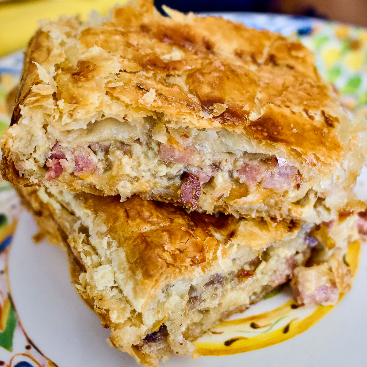 Baked onion and ham puff pastry pie slices square image0
