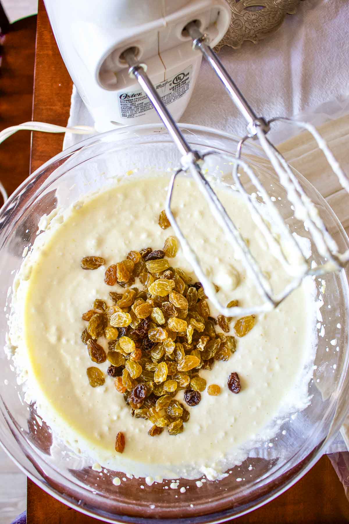 Adding raisins to the cheese.