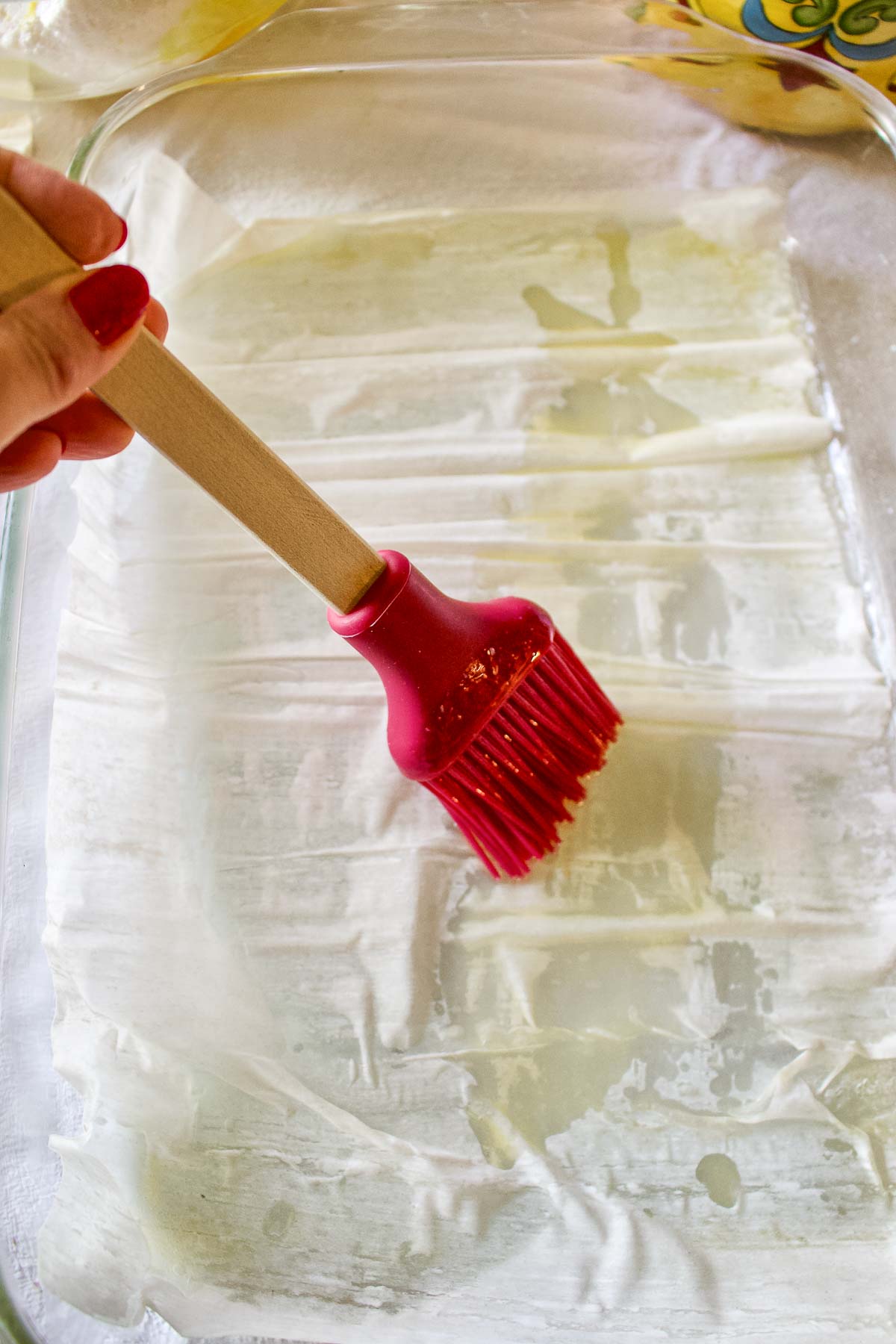 Brushing the phyllo dough with butter.