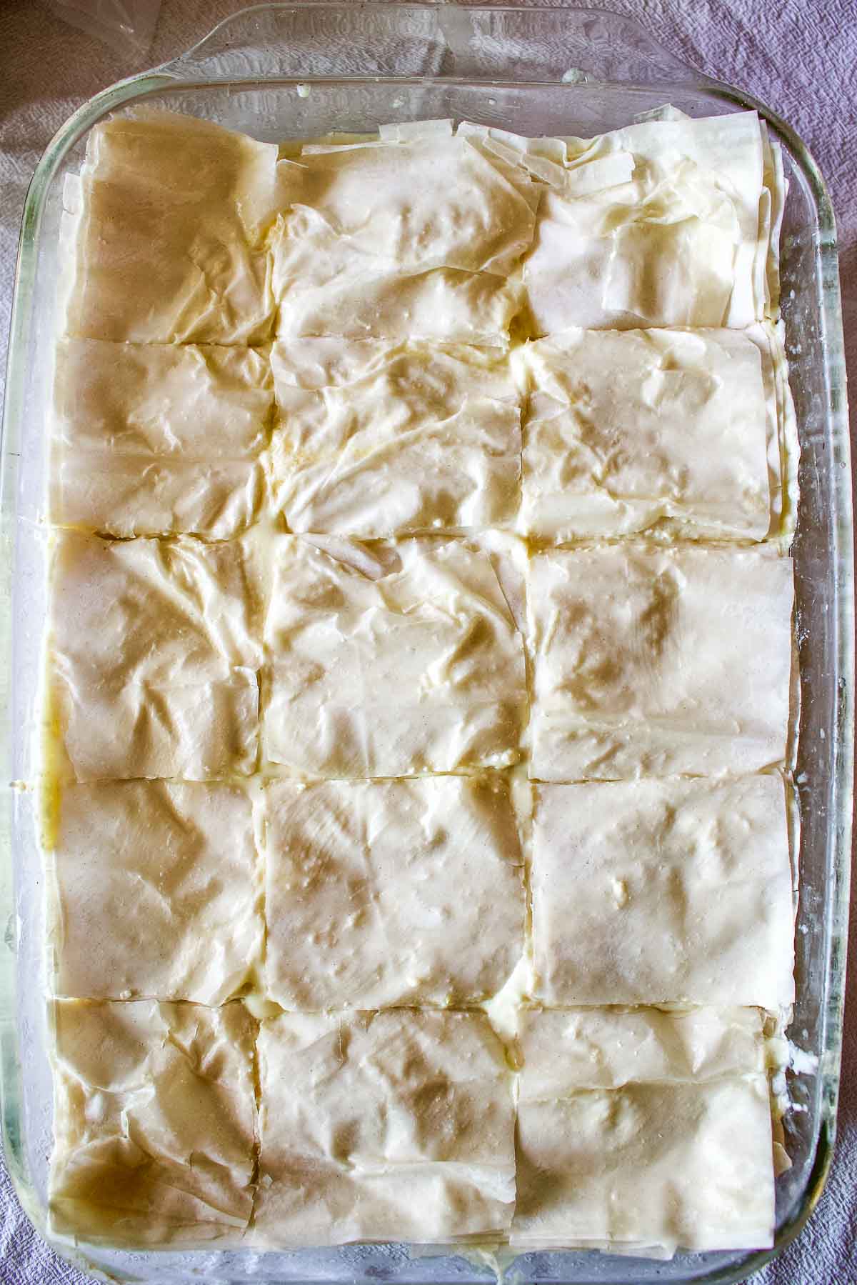 Cutting slices of the unbaked pie in the pan