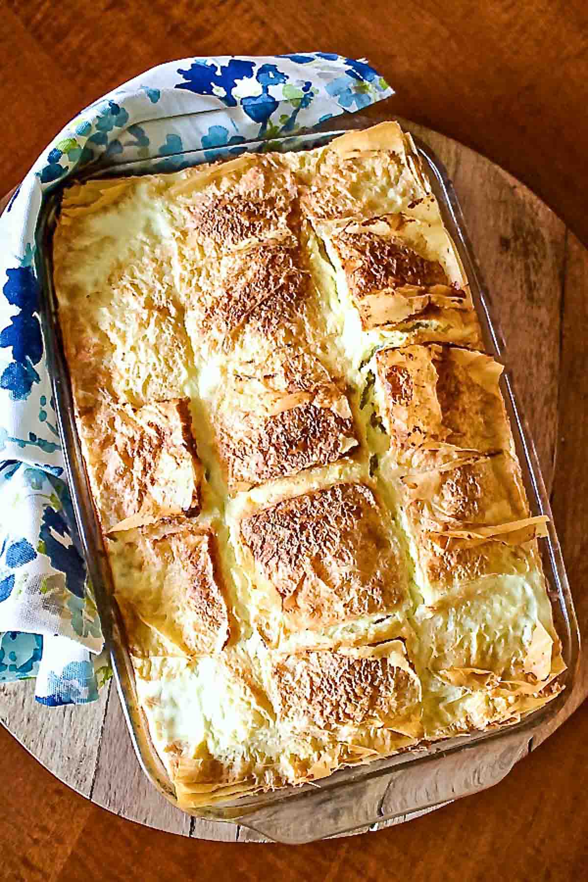 Sweet Cheese slab pie2525 Sweet cheese slab pie out of the oven with towel.