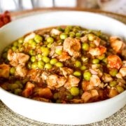 Green Peas With Chicken Stew in a white serving bowl Featured image.
