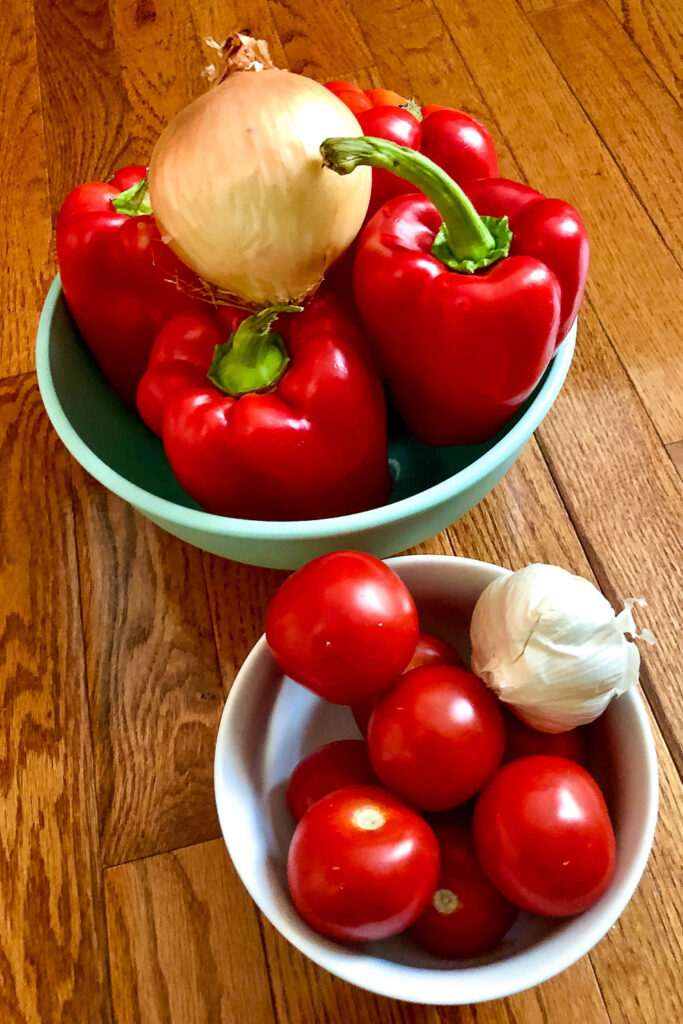Ingredients for Lecso peppers tomatoes onion garlic on table