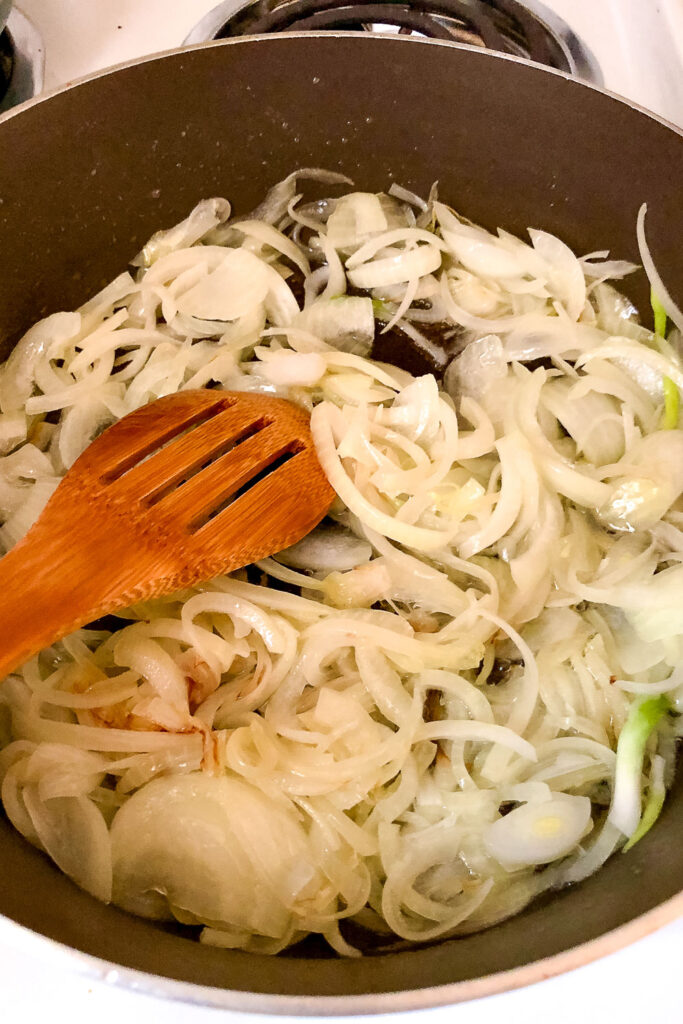 Sliced onions cooking in a pan