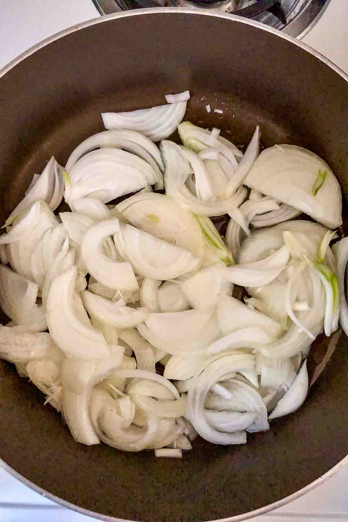 Sliced onions cooking in the pan.