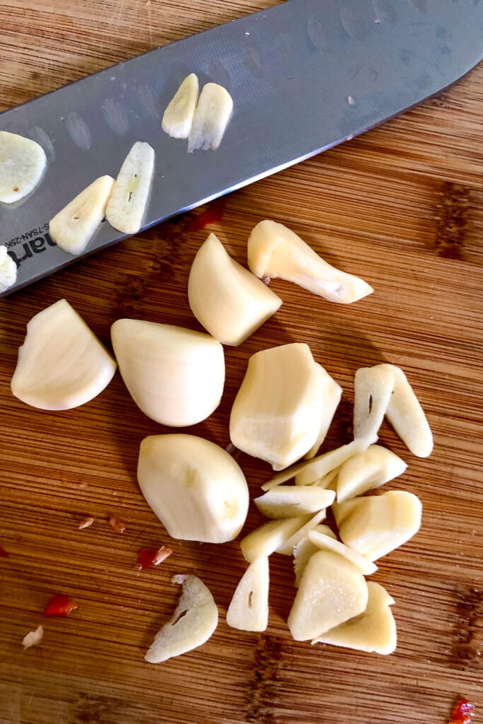 Slicing garlic on wooden board