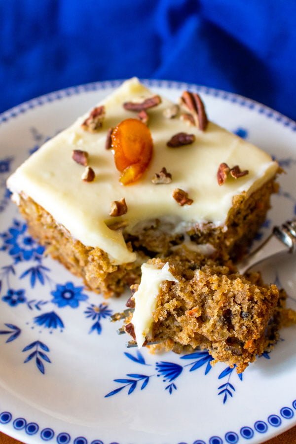 carrot cake with pineapple slice on plate with fork