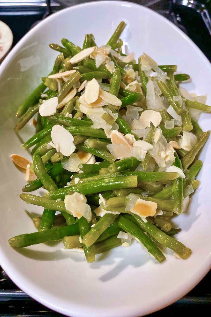 Sauteed Green Beans With Almonds in a white serving bowl.