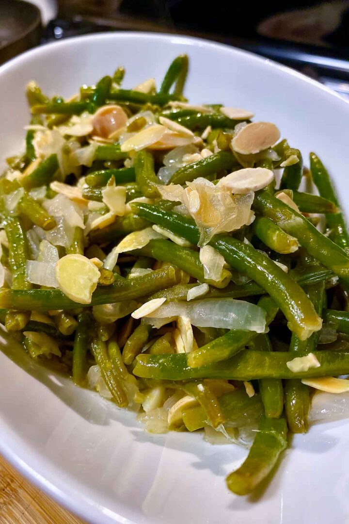 Sauteed Green Beans With Almonds in a white serving bowl1200