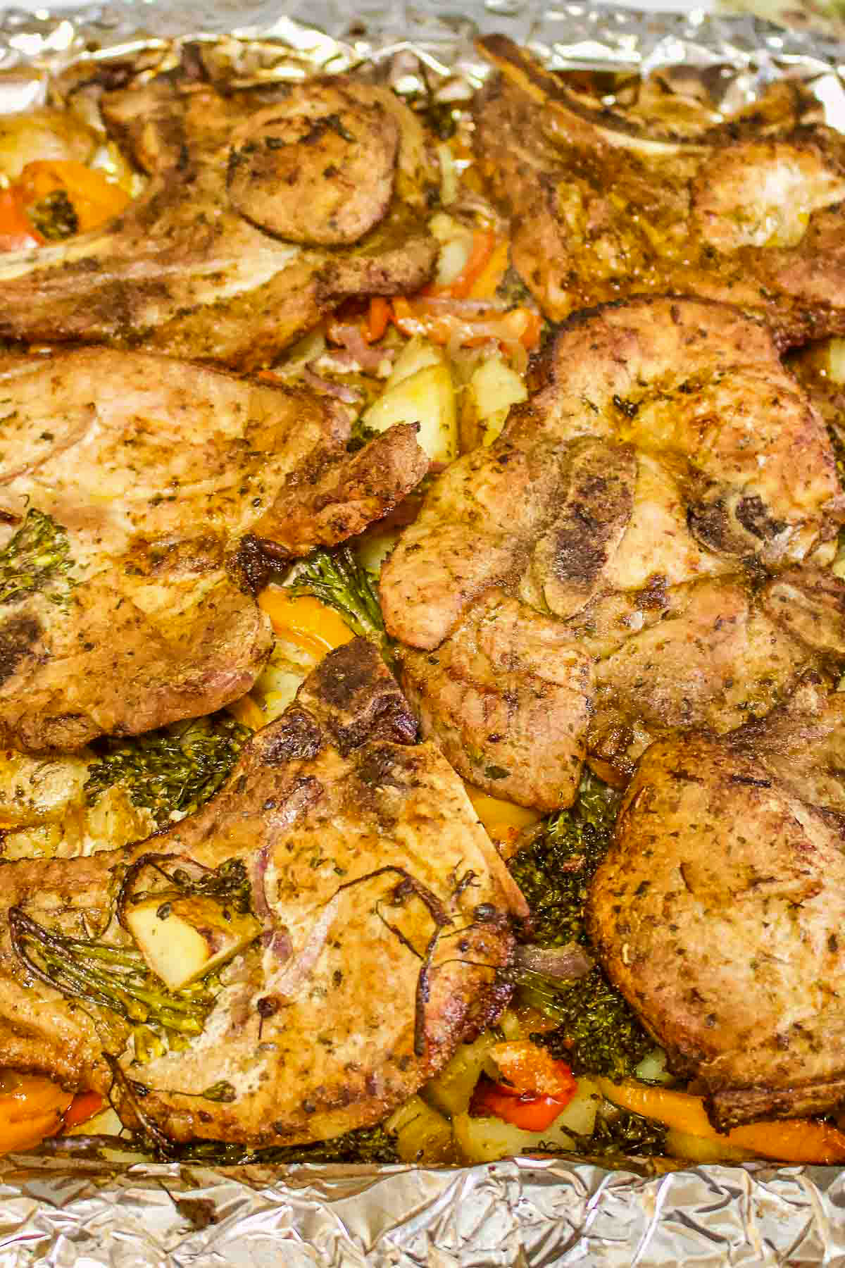 Roasted Pork chops With Vegetables on a baking tray.