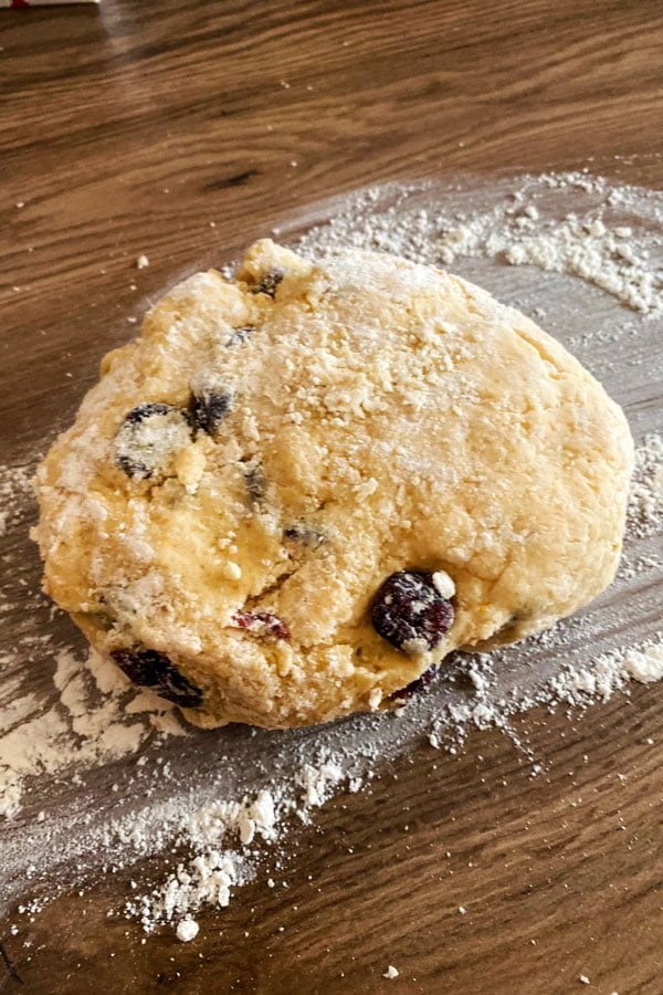 Dough prepared for English scones sitting on a floured table.