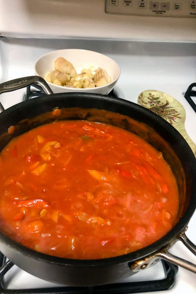 Tomato sauce with peppers and onions cooking