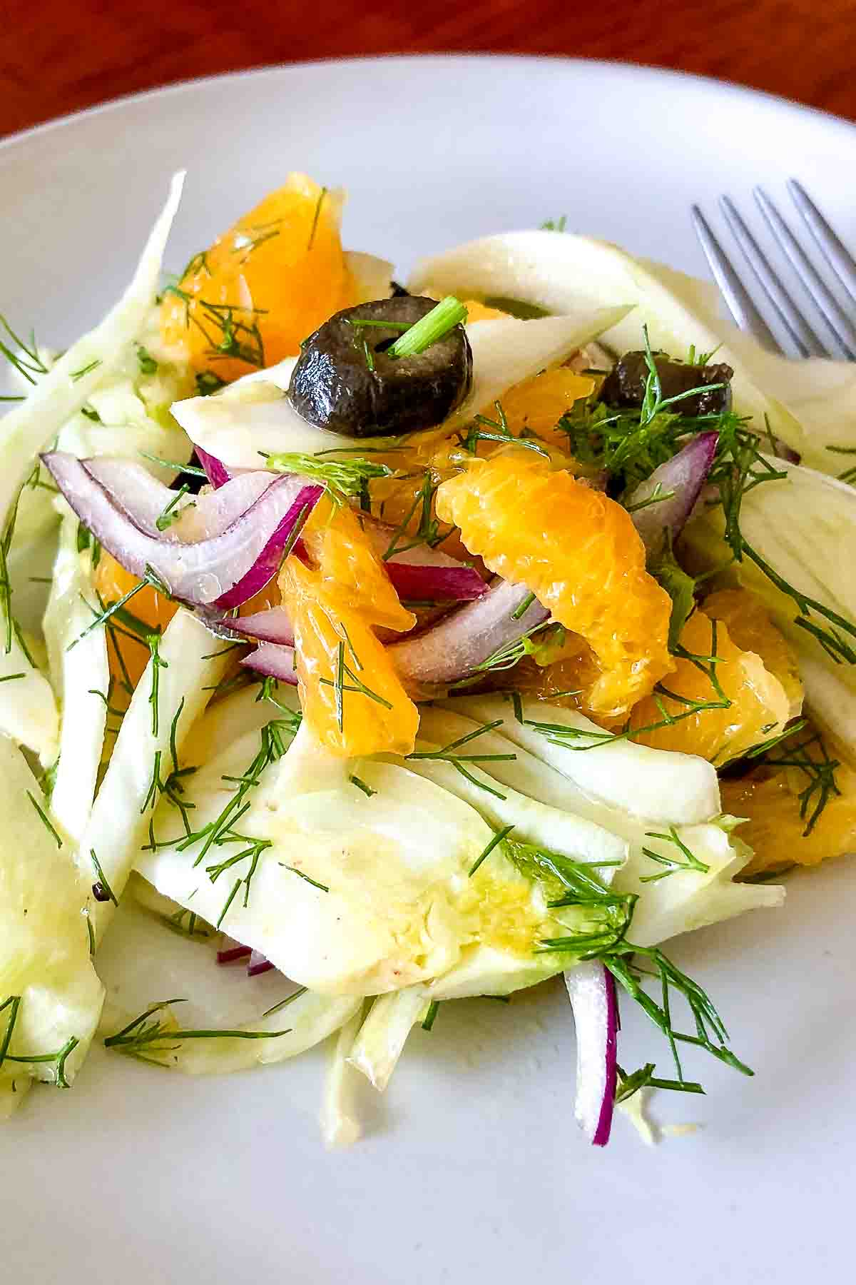 Spanish Orange Fennel Salad served on a white plate with fork.