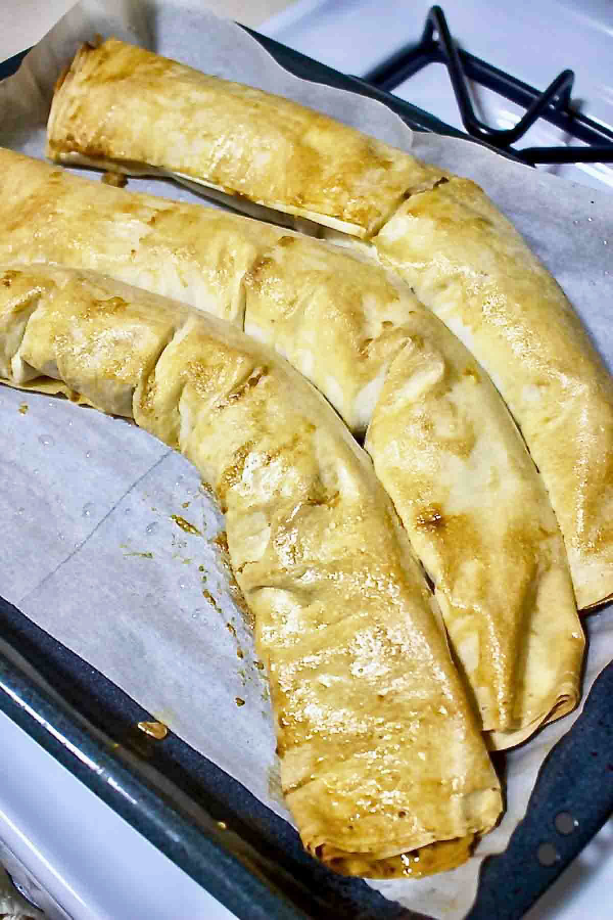 Baked phyllo dough filled with meat and potatoes.