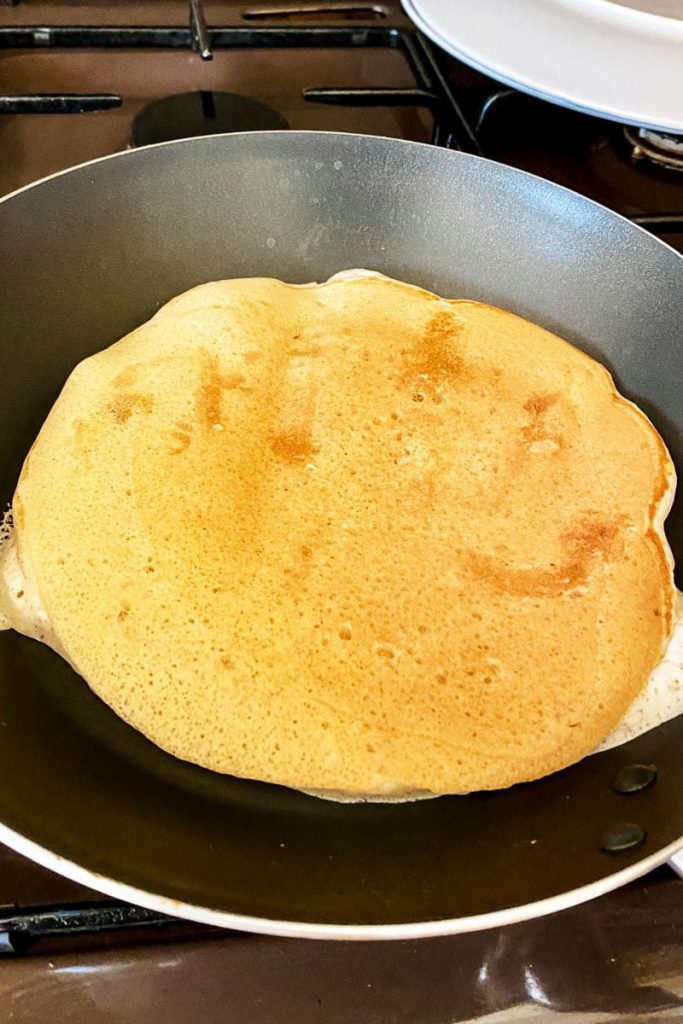 Banana Buttermilk Pancakes cooking in the pan
